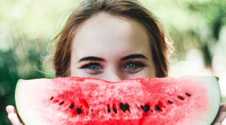Woman holding a slice of watermelon representing Grubbits